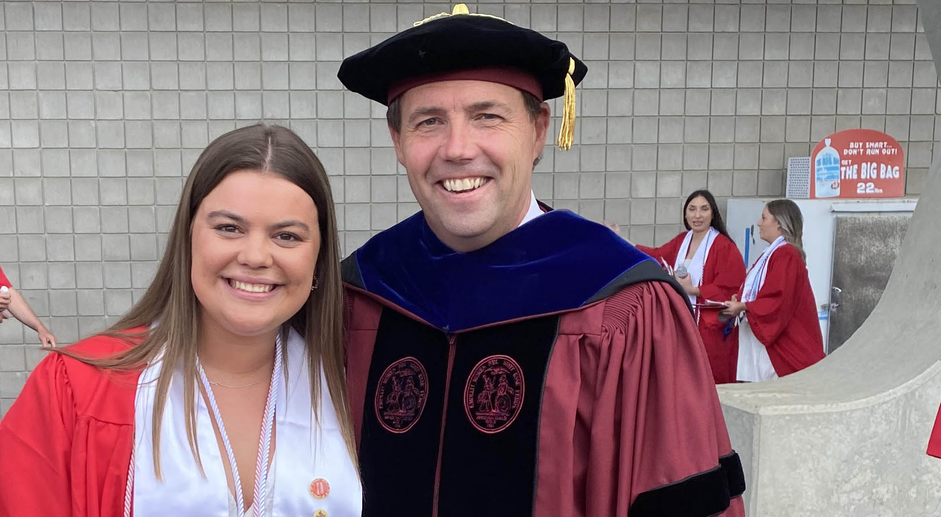 Photo of David Shrider at graduation with a student