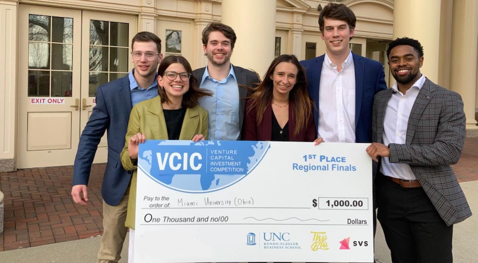 VCIC regional champions holding a $1,000 check