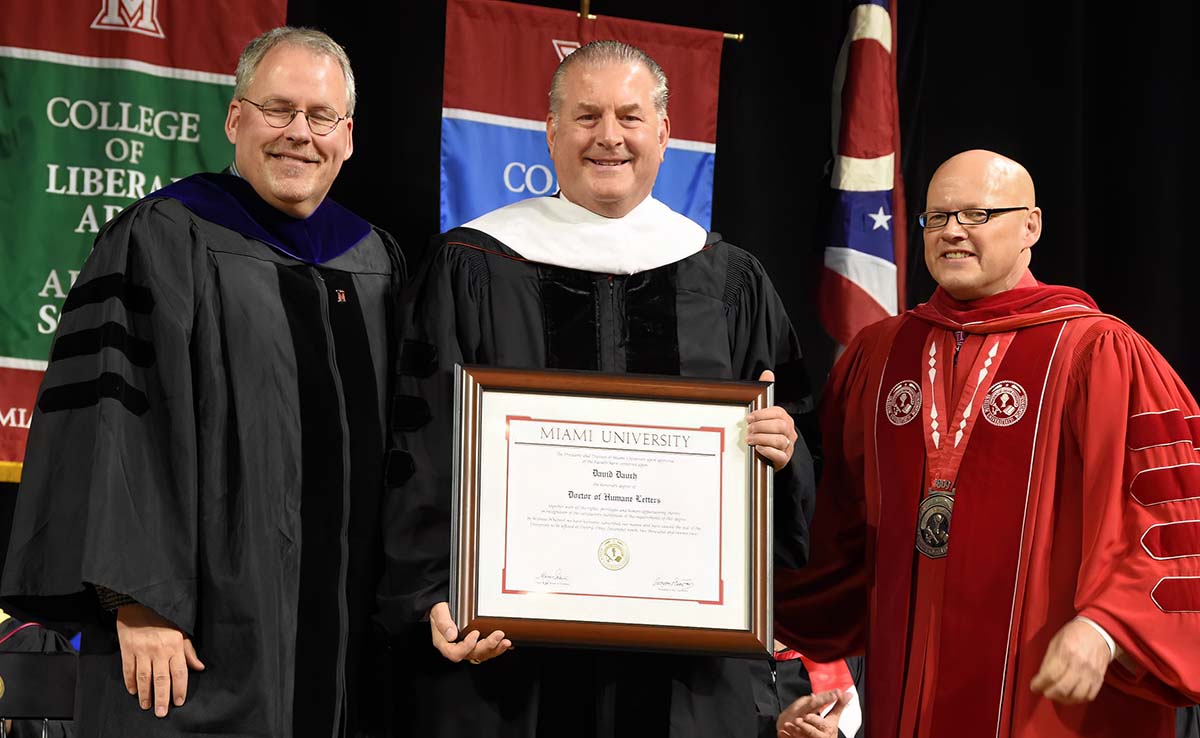 David posing with his diploma