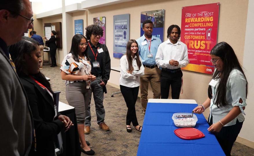 Students take part in a Six Sigma game at Cintas
