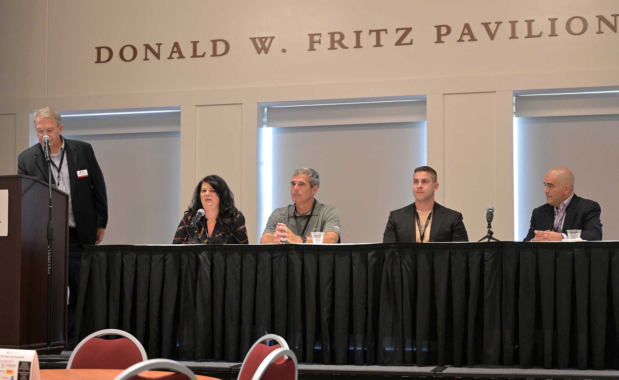 Panelists at front of room behind table