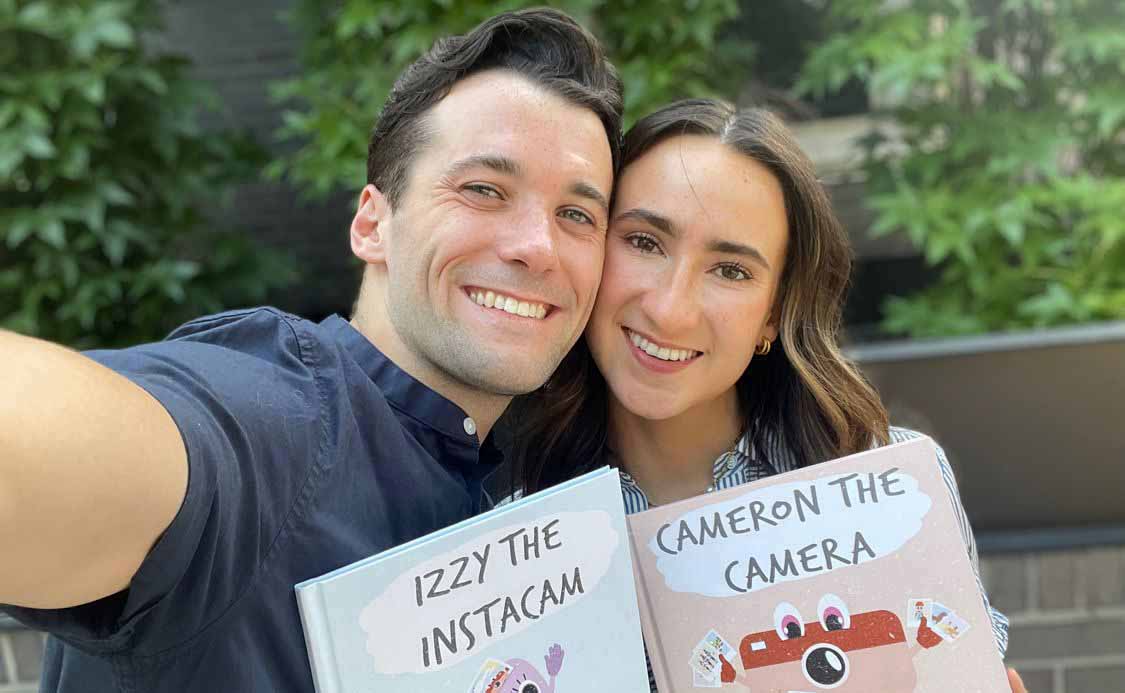 The authors holding the books