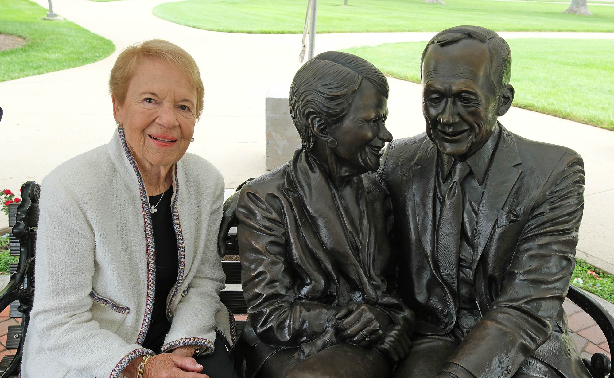 Joyce Farmer sitting with the sculpture