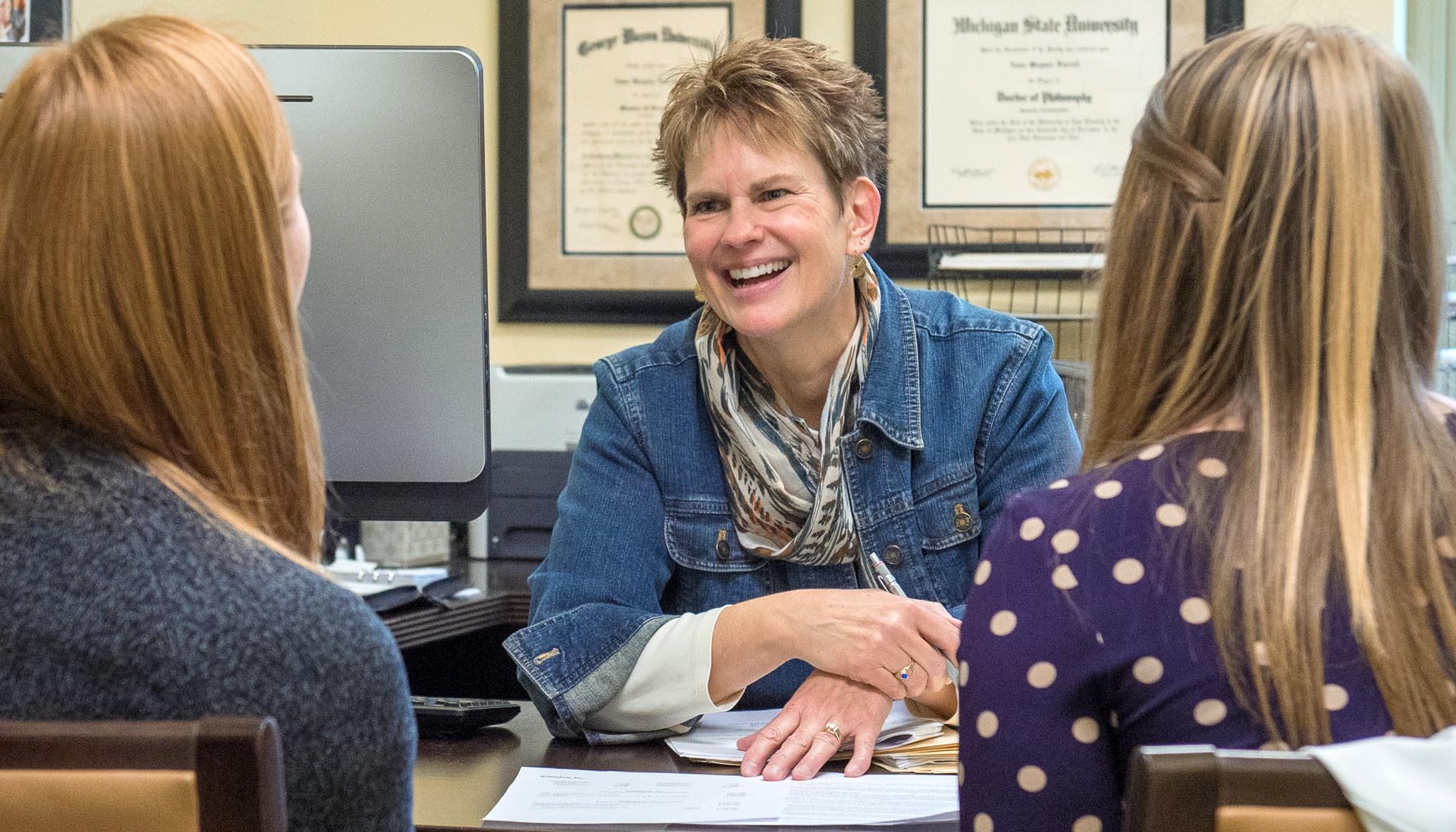 Anne Farrell talking to students in her office