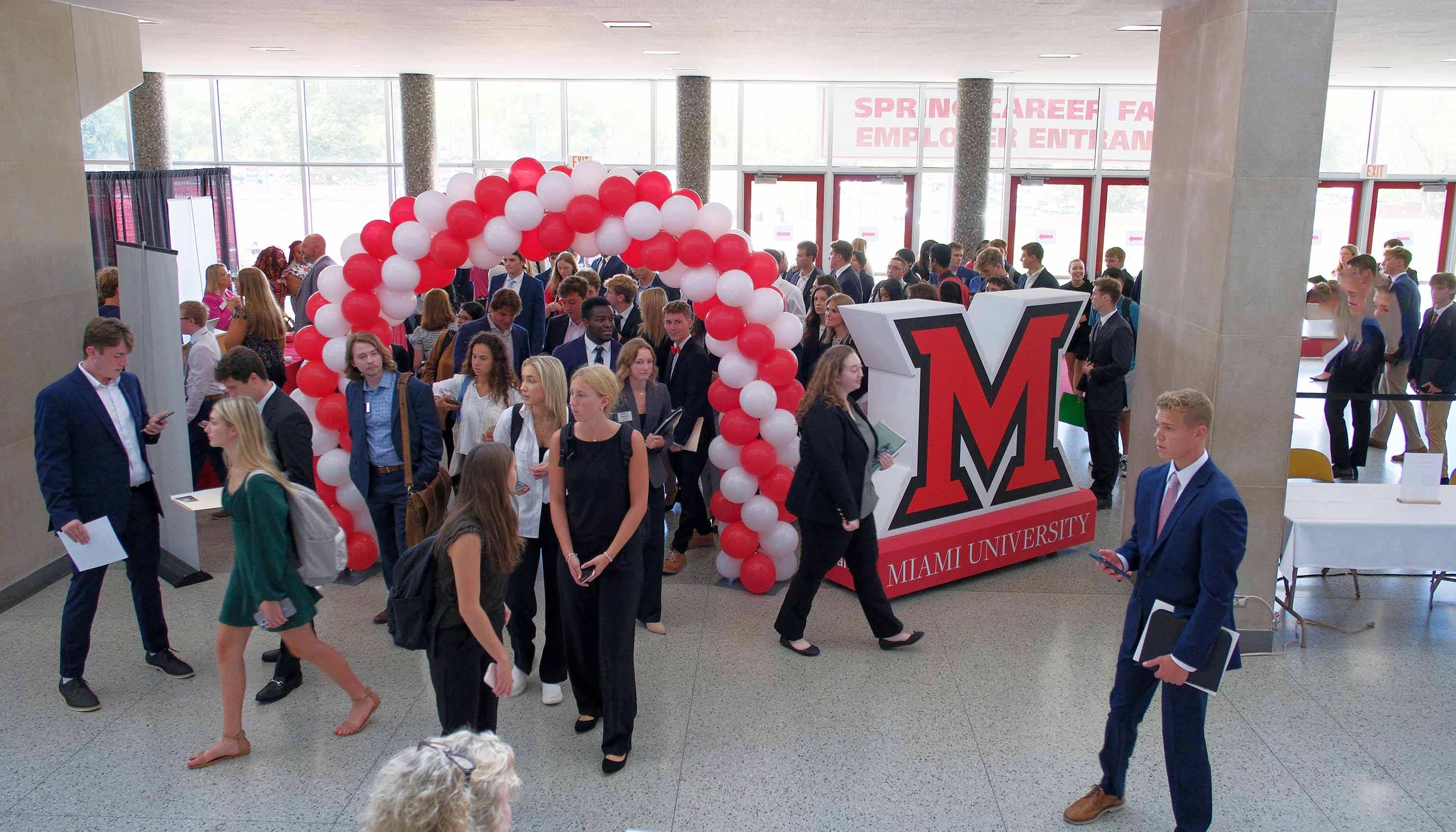 Students entering the career fair through a balloon arch