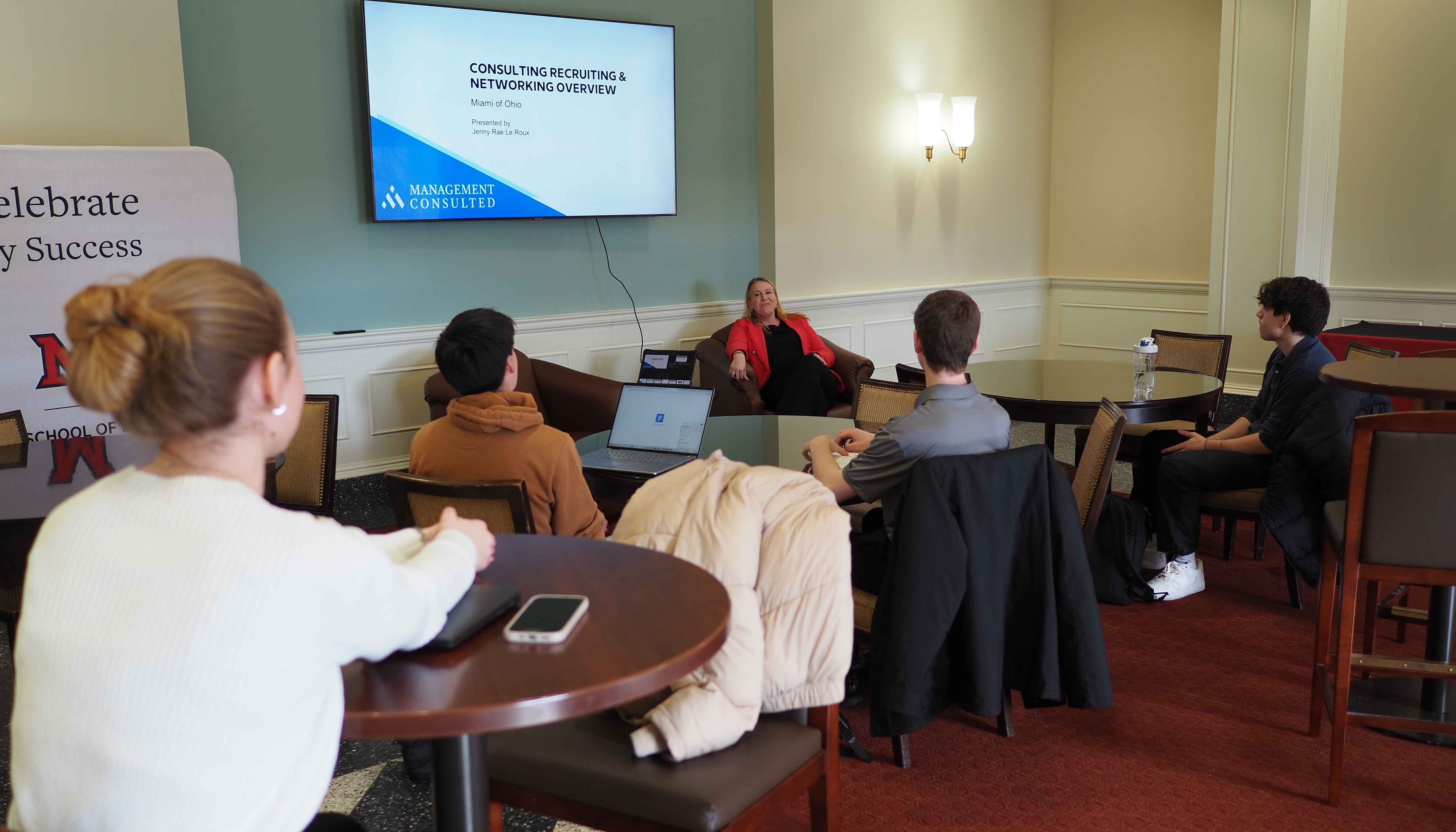 Students listen to a lecture during a consulting event