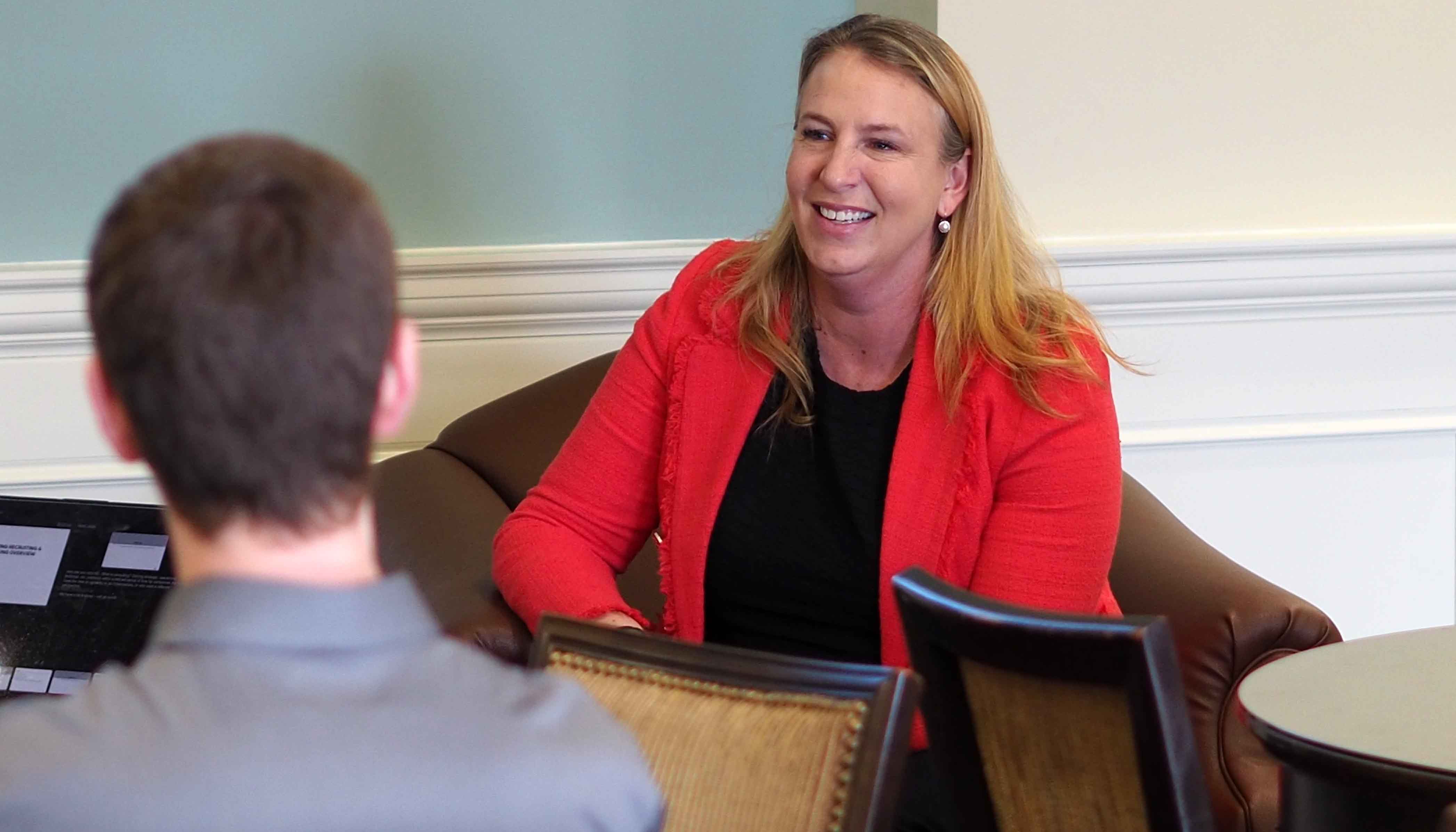 Consulting lecturer talks with students