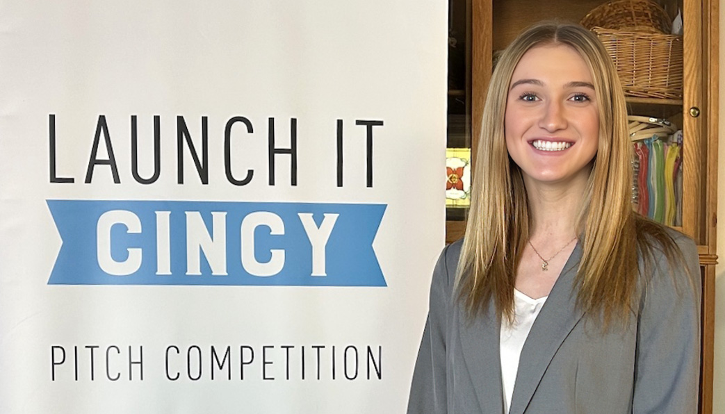 Ella Rumpke poses by Launch It: Cincy sign