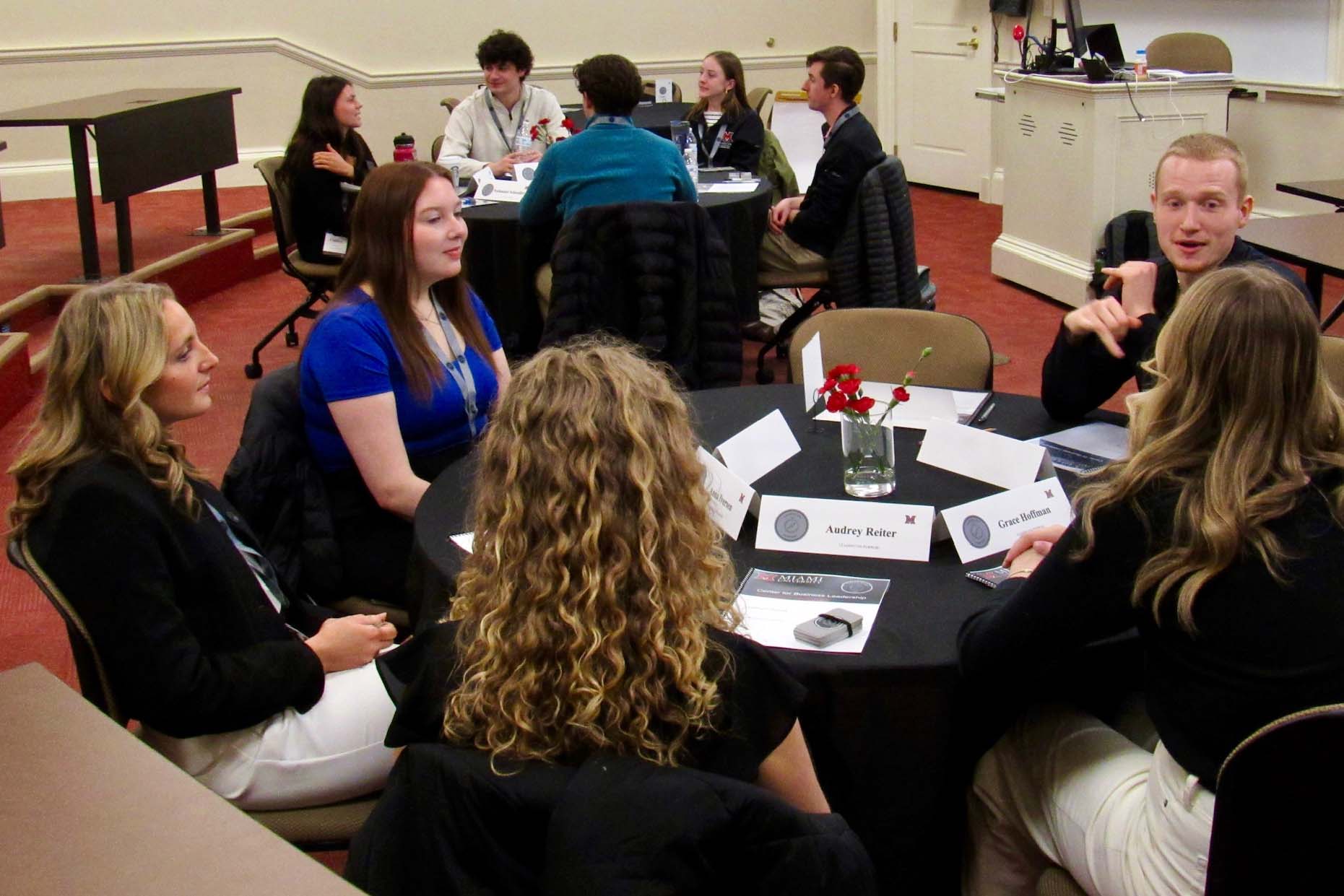 Students talking with one another during the seminar (wide angle shot)