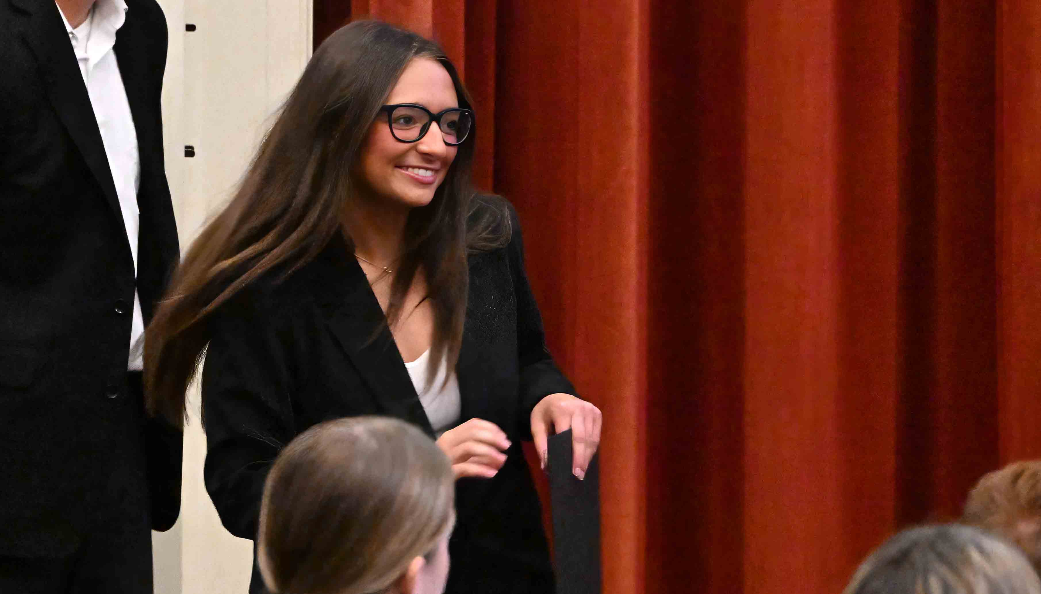 Smiling student walks away after shaking hands