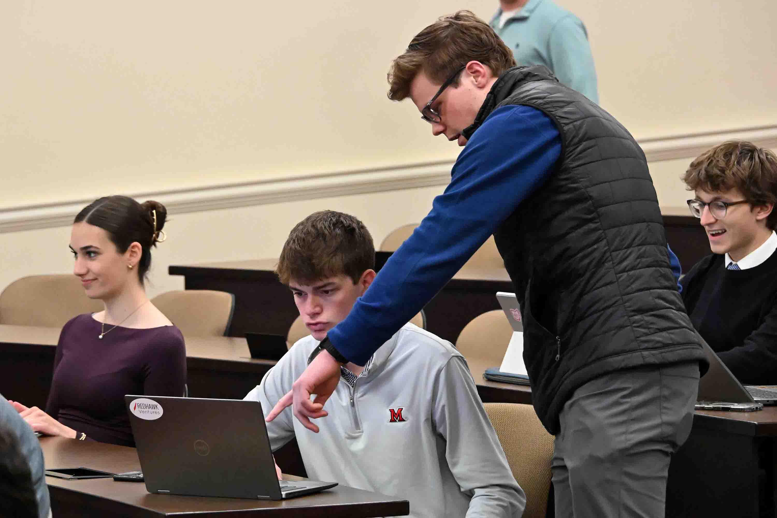 Student in club pointing at other member's computer