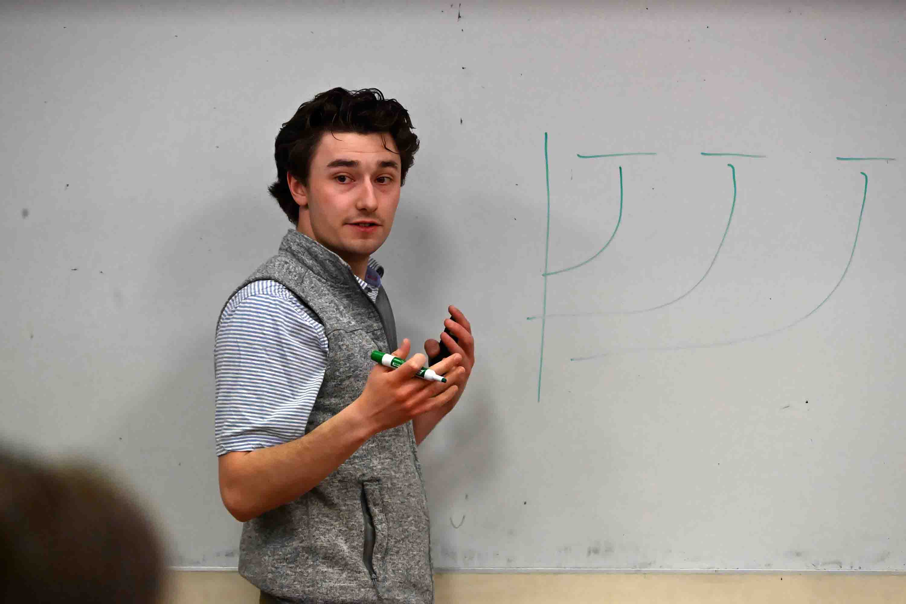 Student making point on whiteboard