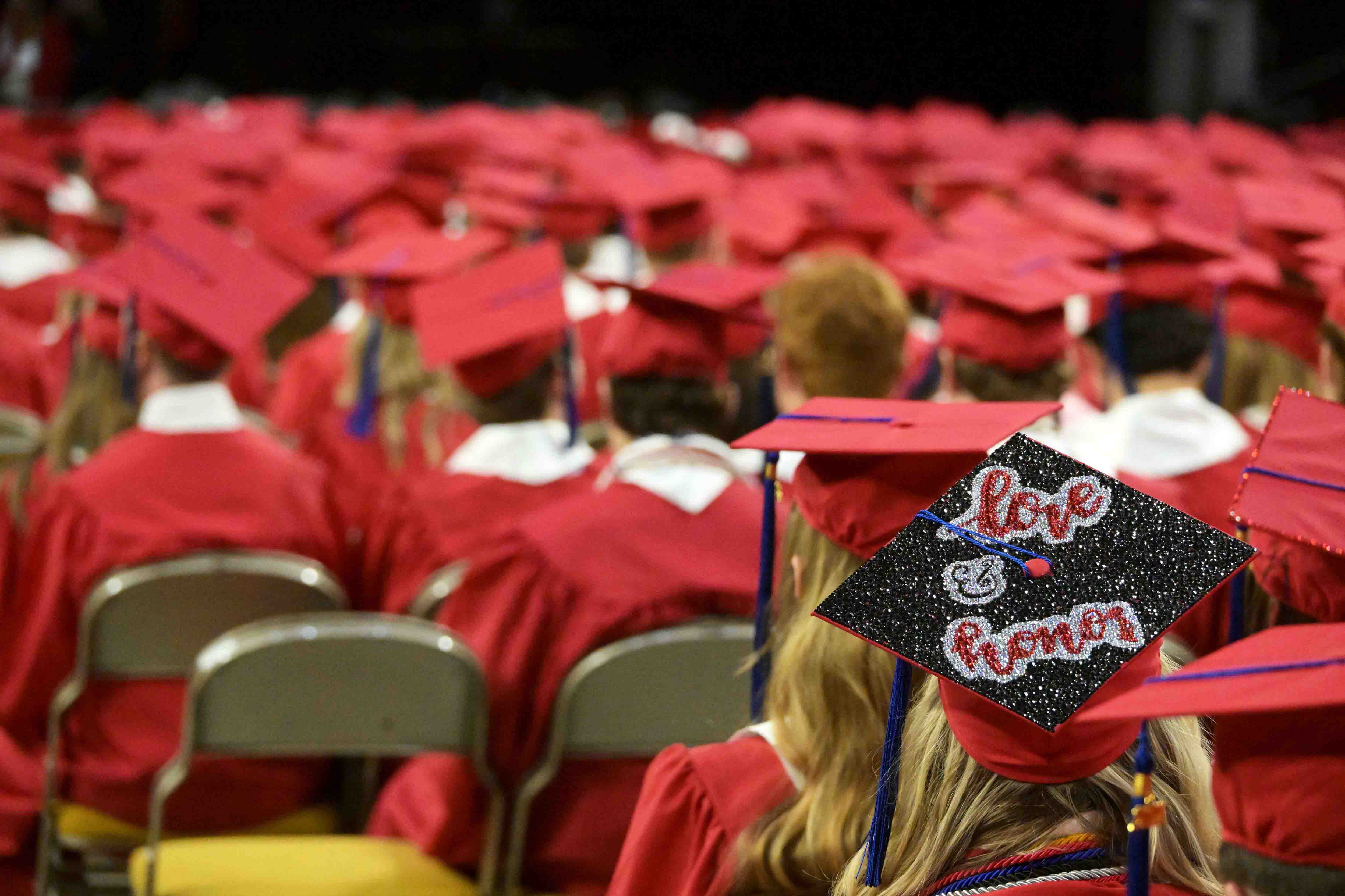 Sea of caps with one written with Love and Honor