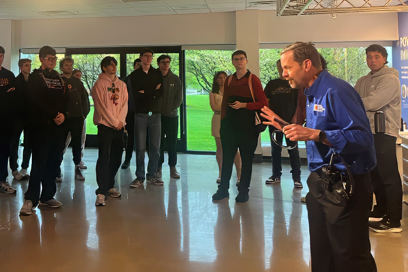 Toyota employee talking to students at factory