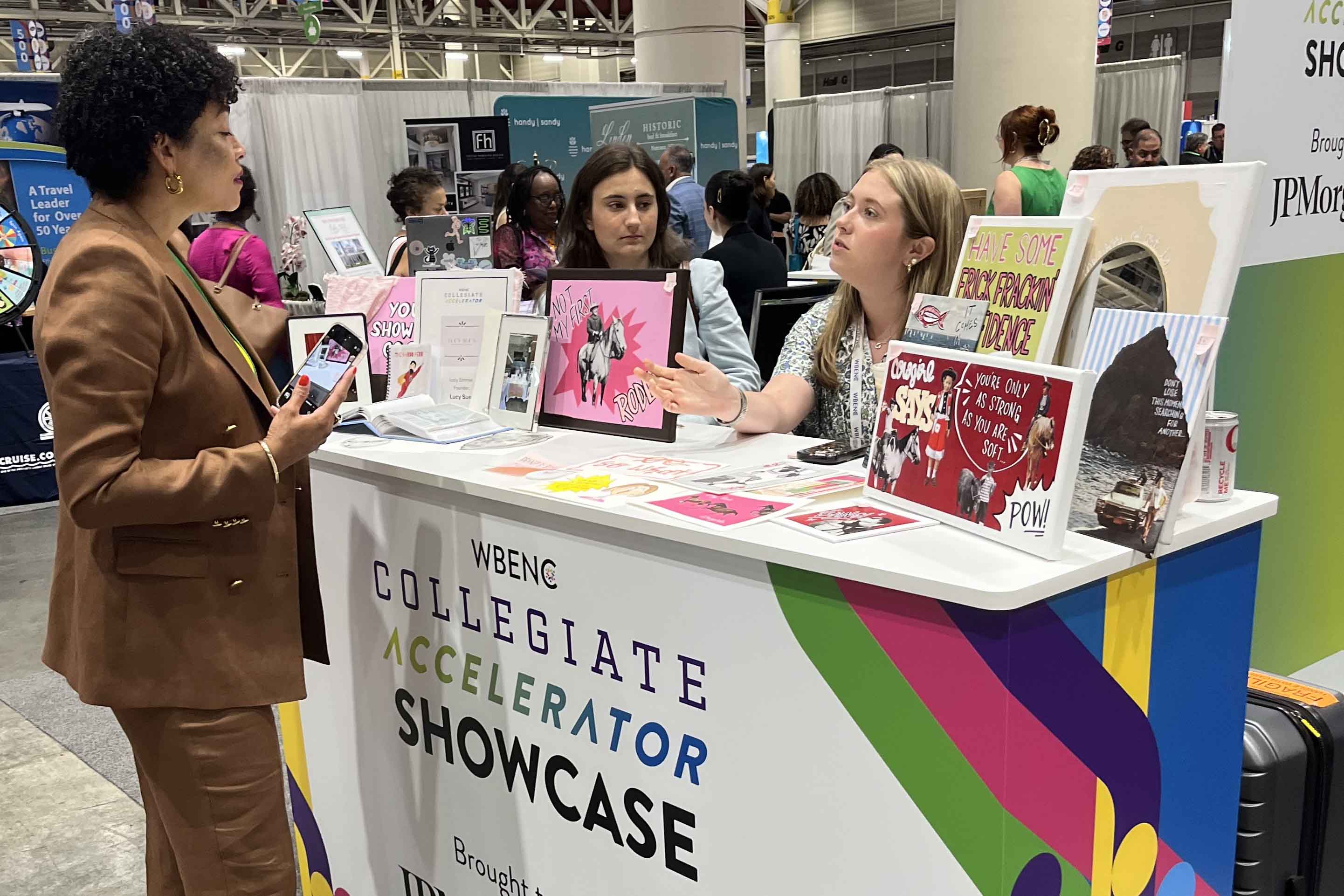 Zimmer talking with visitors to her booth at the convention