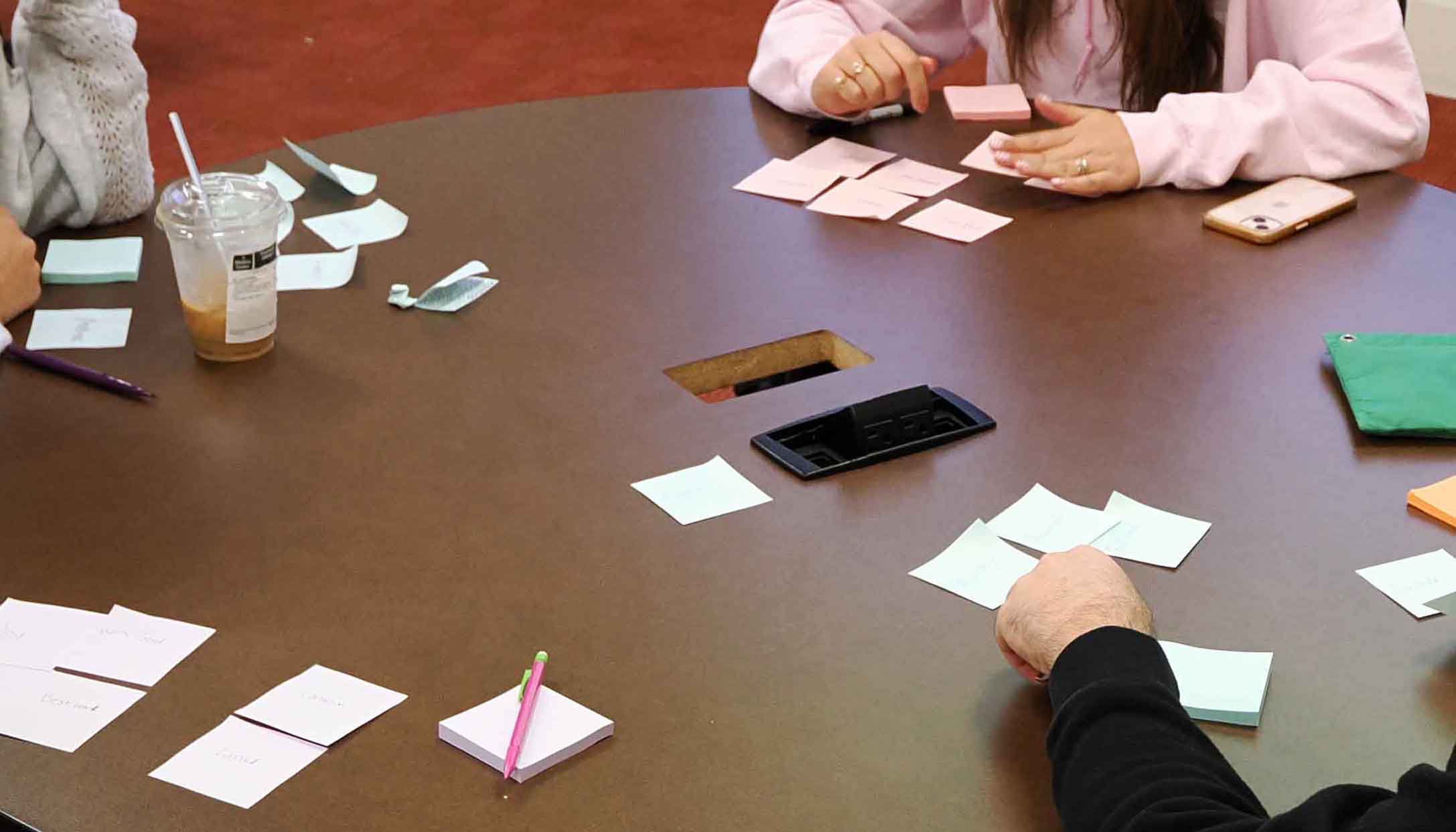 Students writing on post it notes