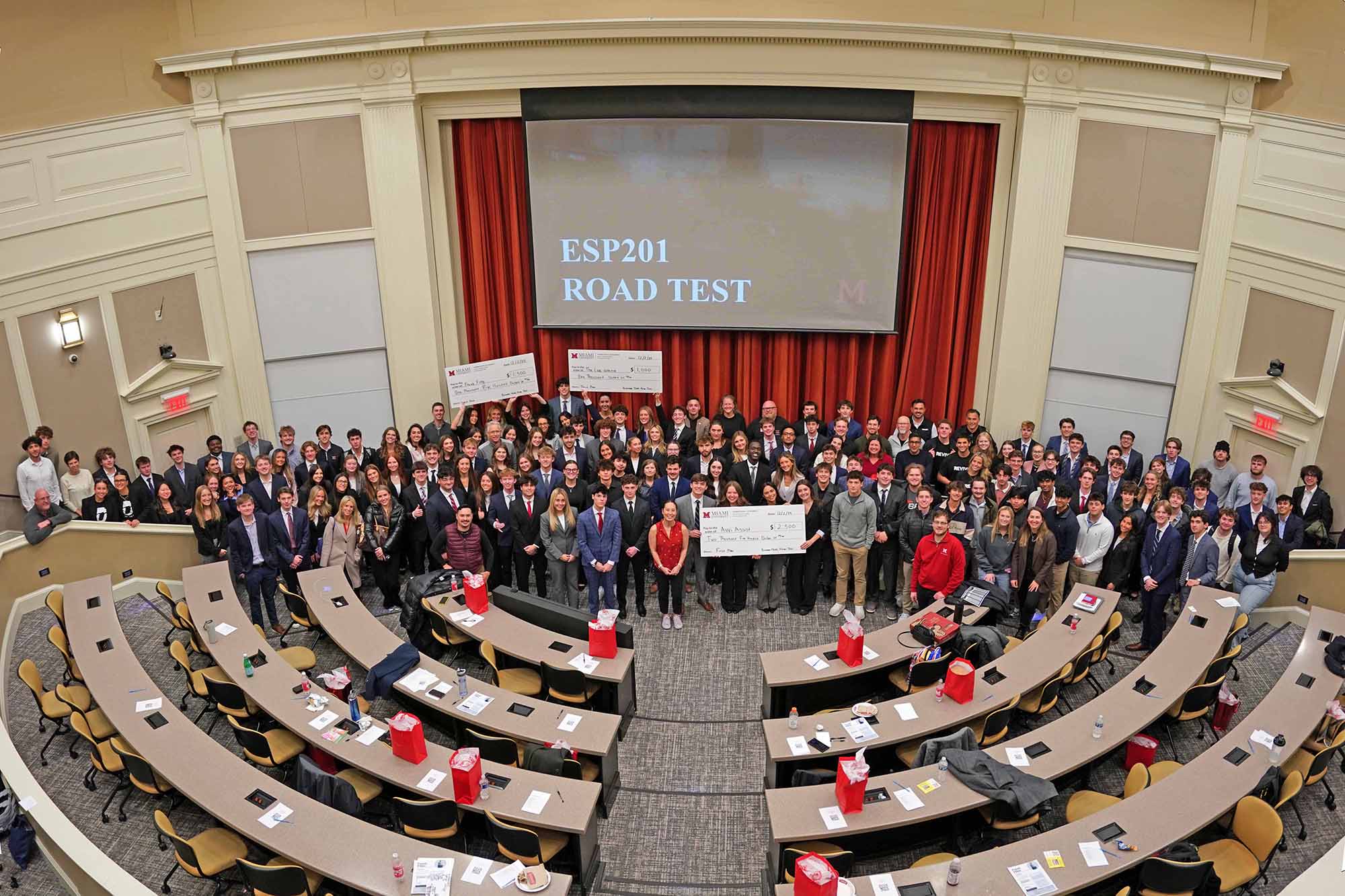 A gathering of students and faculty in a university auditorium for the ESP201 road test event, with a large presentation screen displaying the event title.