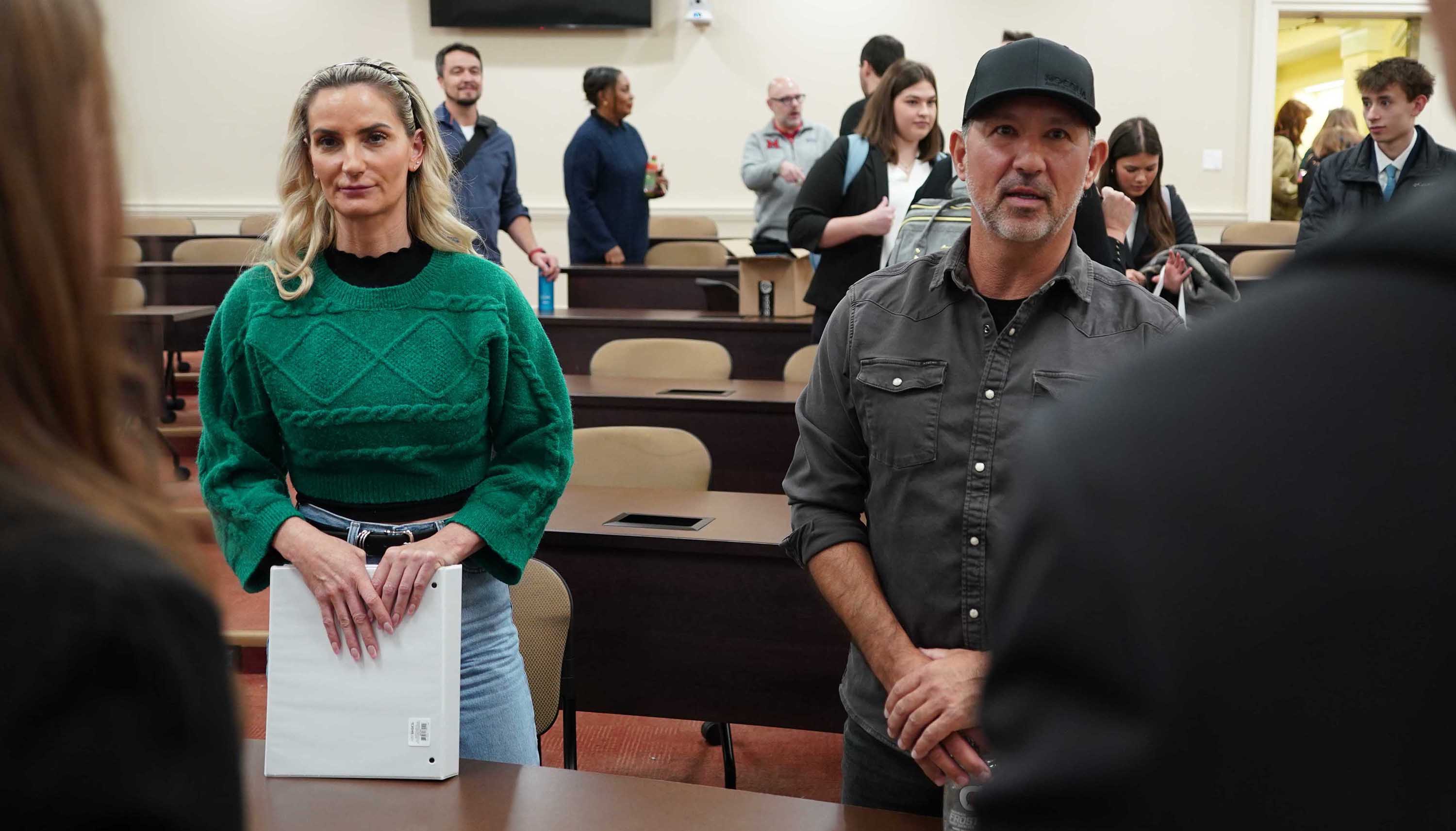 Billy Rossini (R) and Heidi Klein (L) talk with students after the final presentations