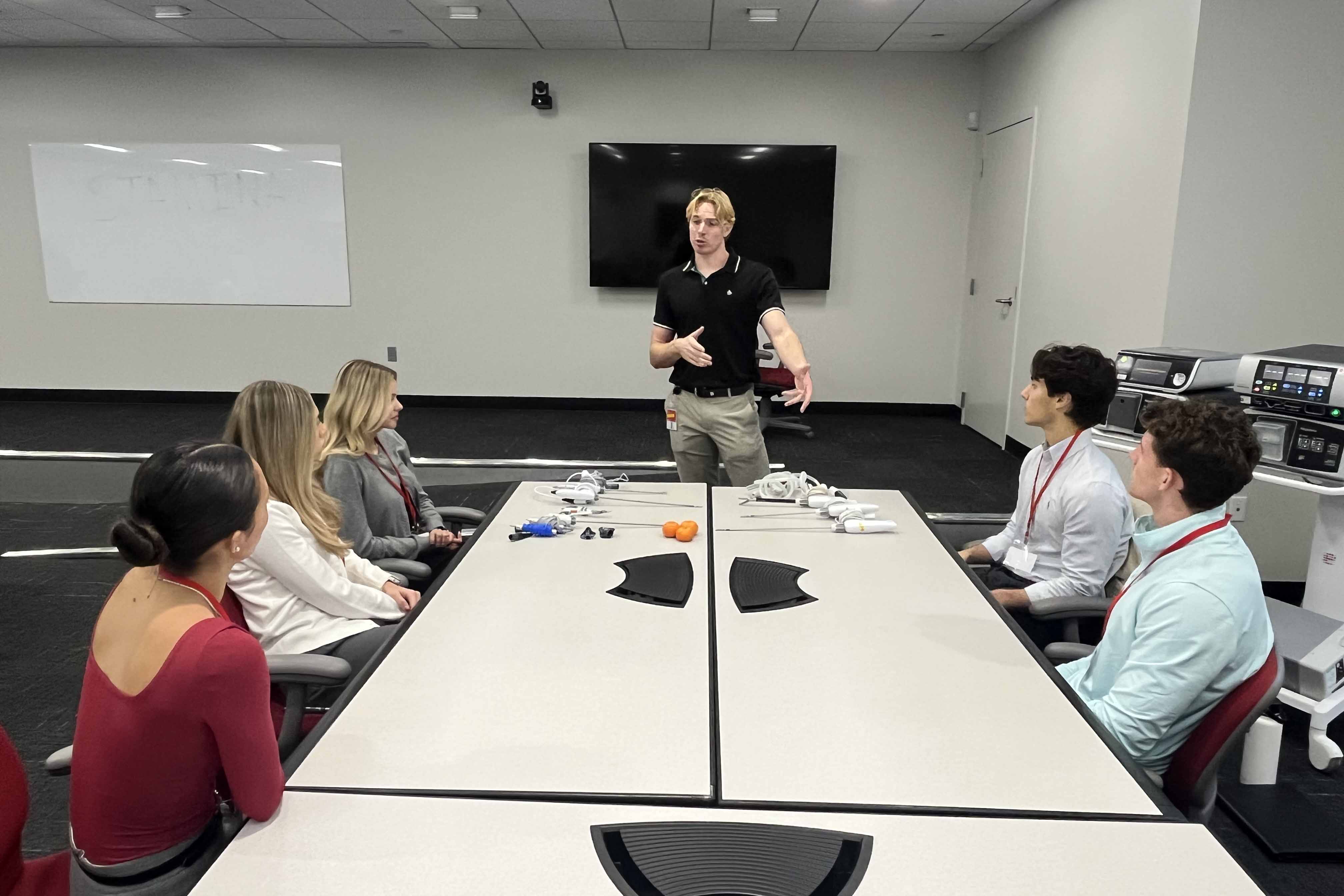 An executive demonstrates a piece of medical equipment