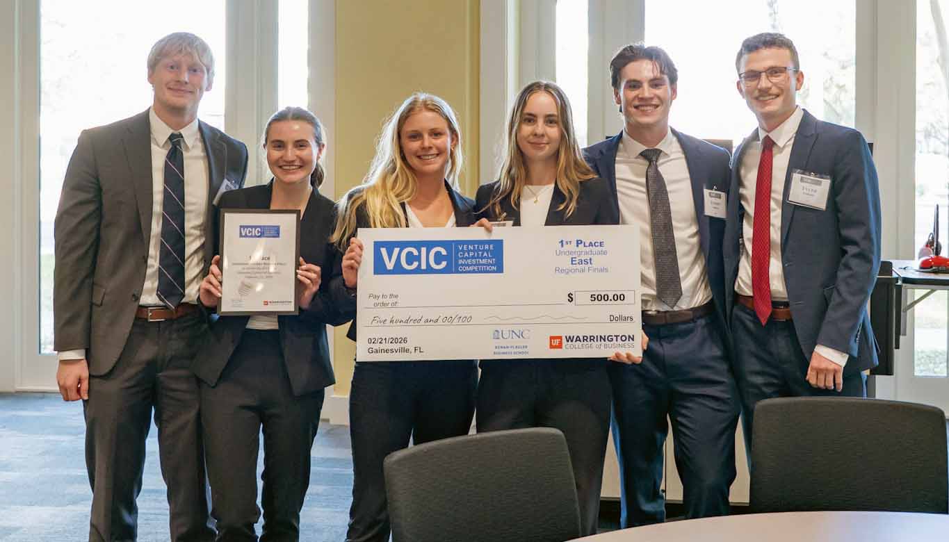 Student team holding a VCIC Venture Capital Investment Competition first-place check and certificate.