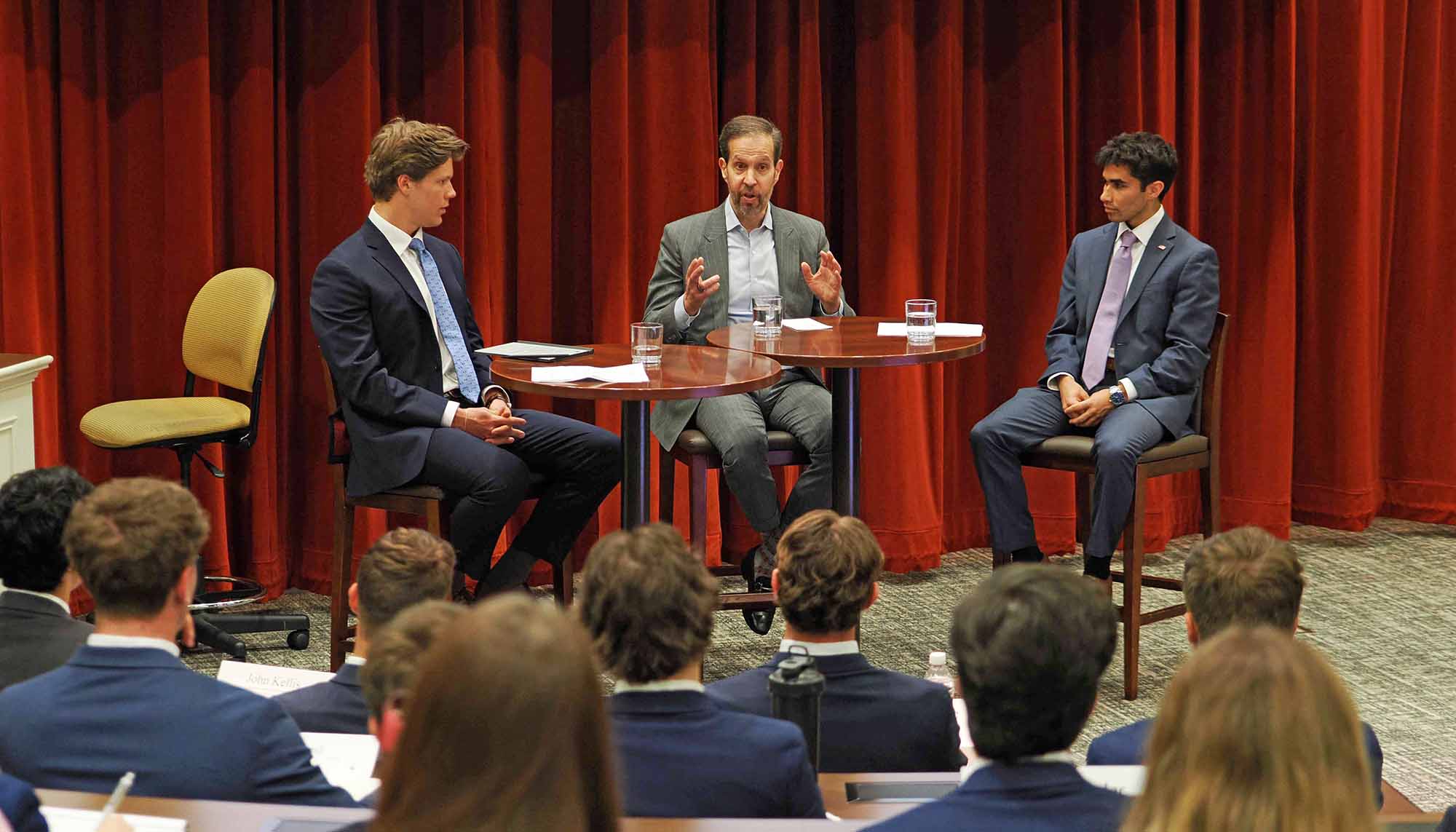 Ken Mehlman (center) talking with students
