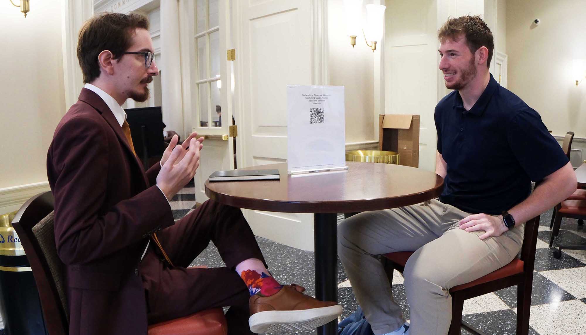 Connor Richman talking with a student at a recent Networking Friday event
