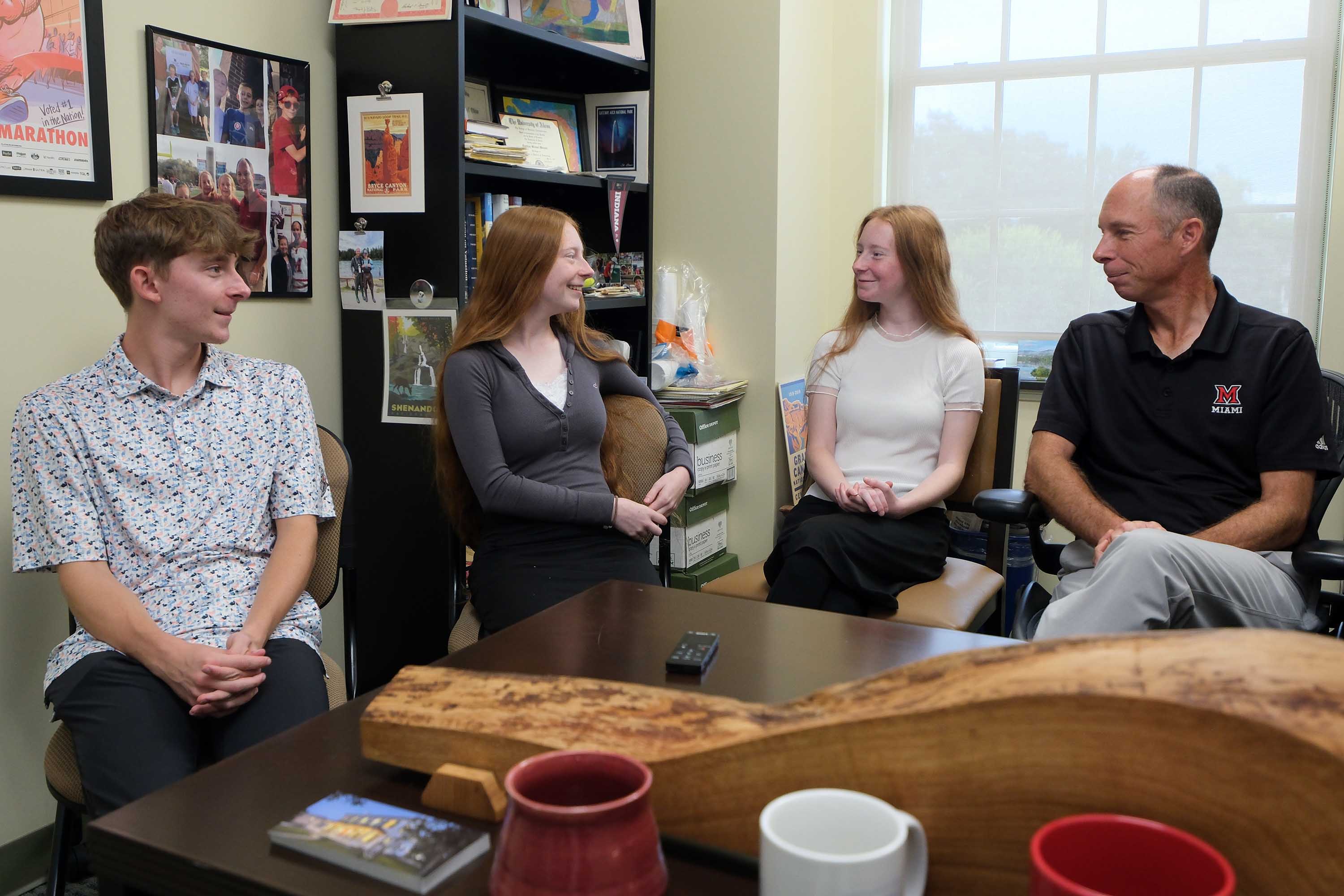 The Wielands talking in Matt Wieland's office