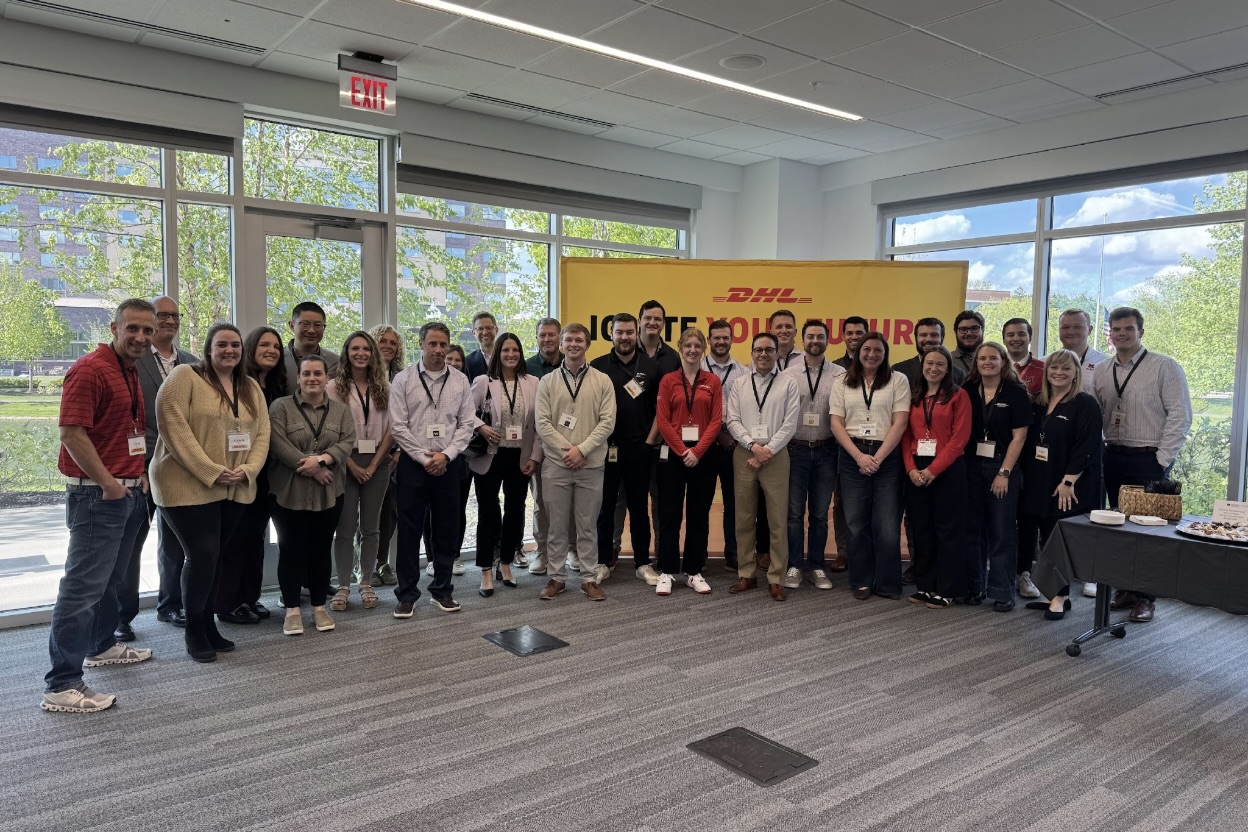Group photo in front of DHL banner