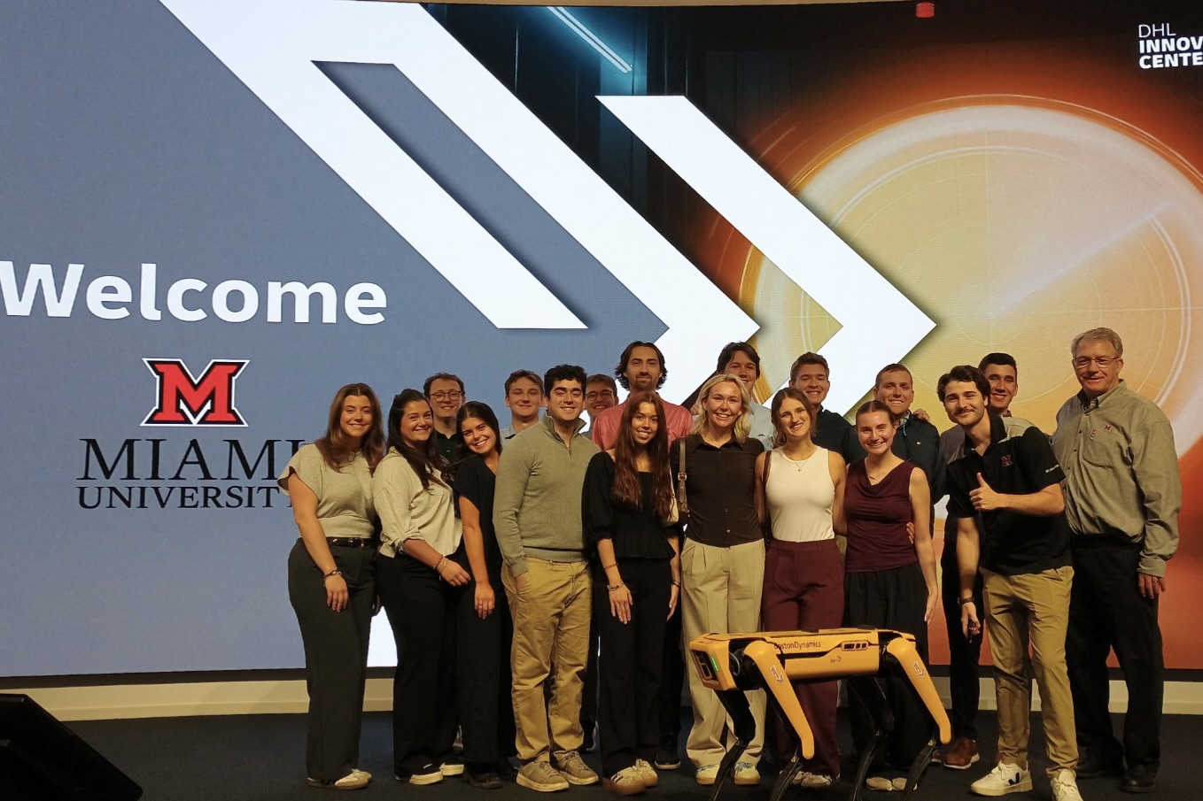 SCMA group in front of illuminated display