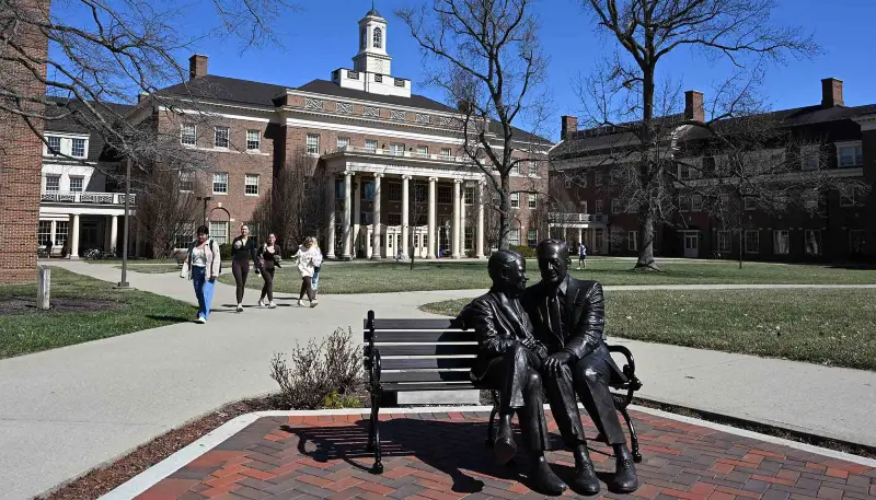 farmer statue in front of the school of business on a spring day