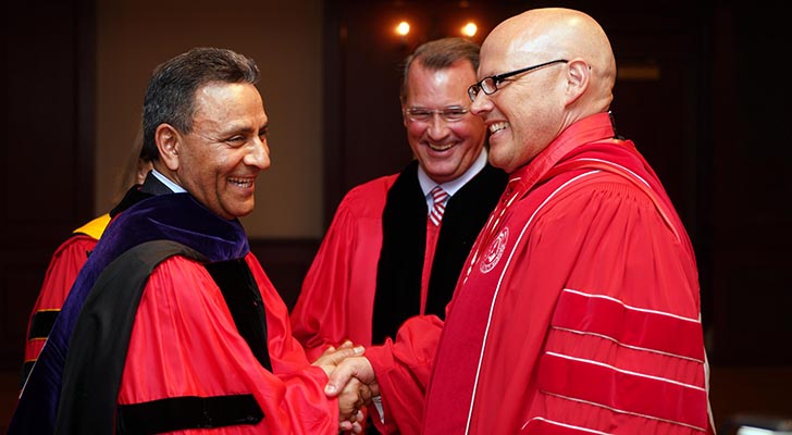 Dinesh Paliwal shakes hands with Miami University President Gregory P. Crawford