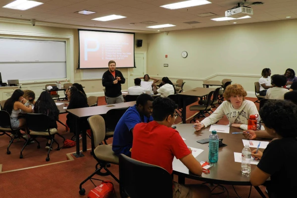 group of students in classroom with professor at front