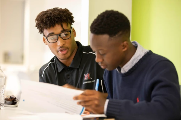two male students studying in classroom