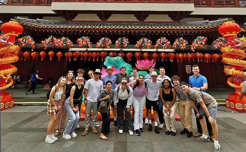 FSB students travelled to Singapore, posing together in front of a pagoda