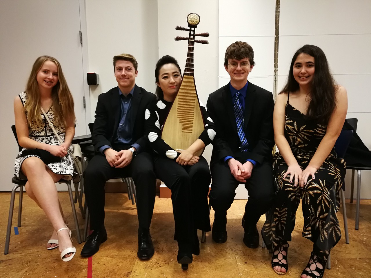 musicians pose with their instruments