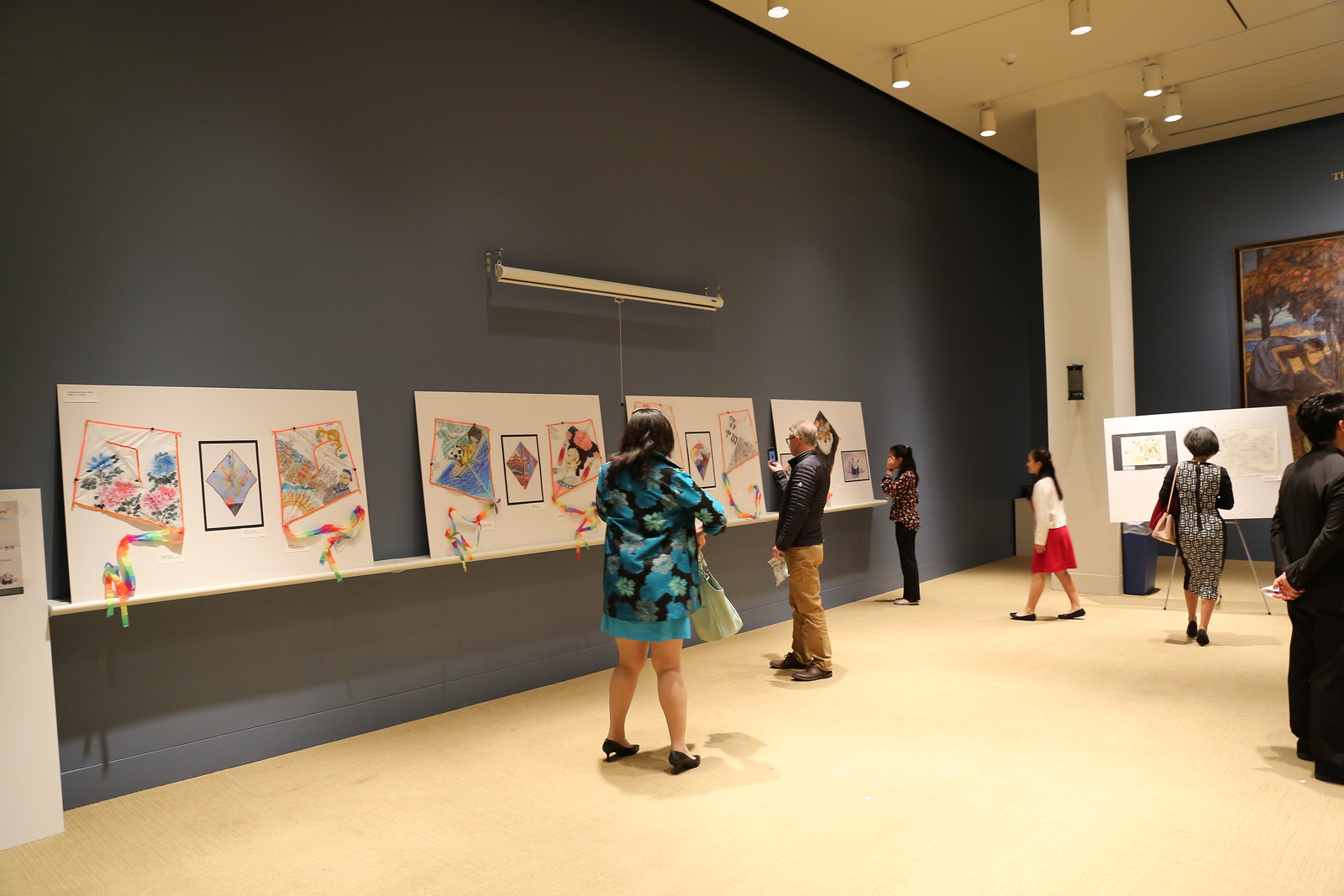 a woman admires art in a gallery