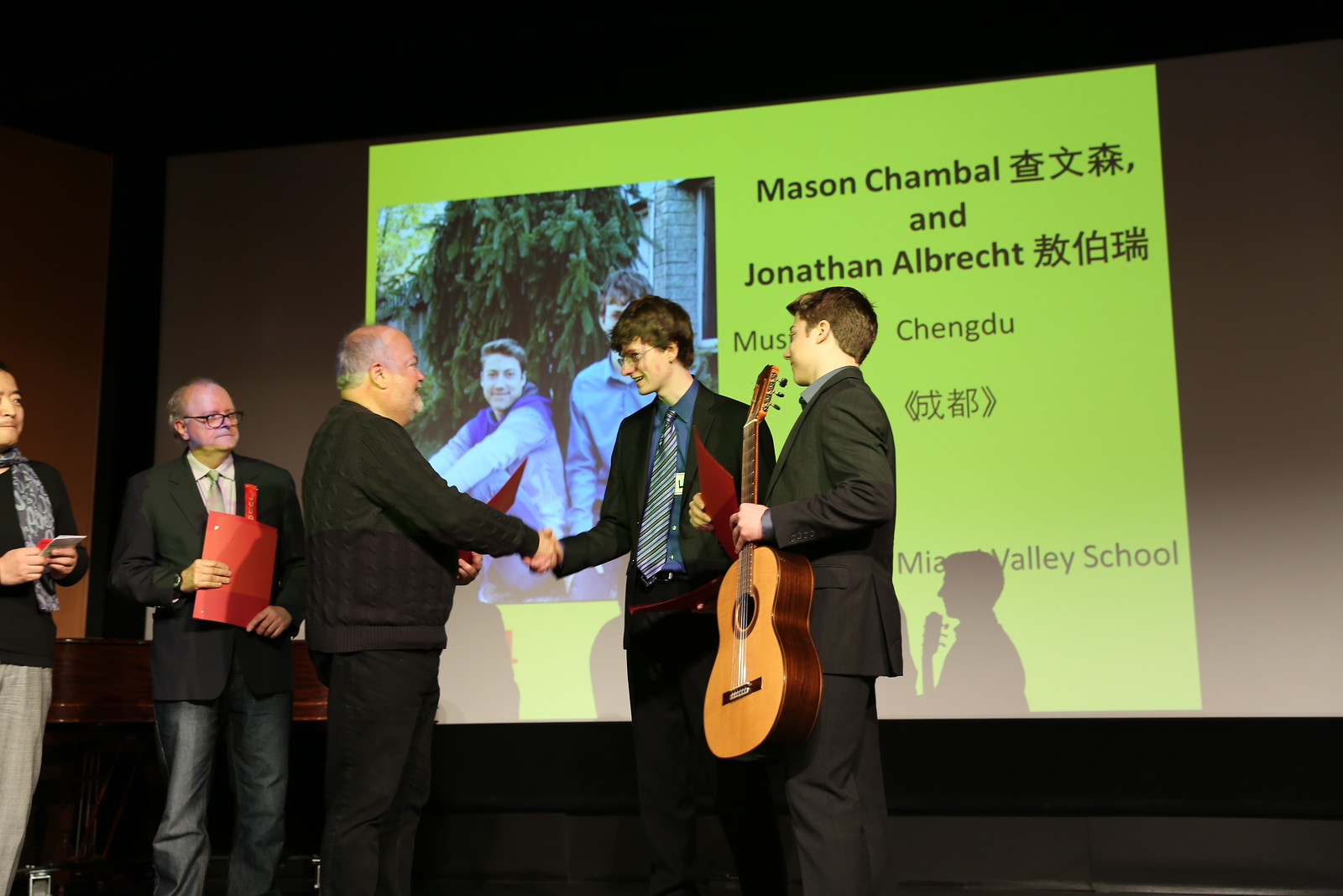 musicians shake hands on stage