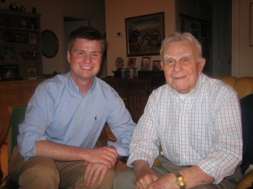 student poses with John Dolibois