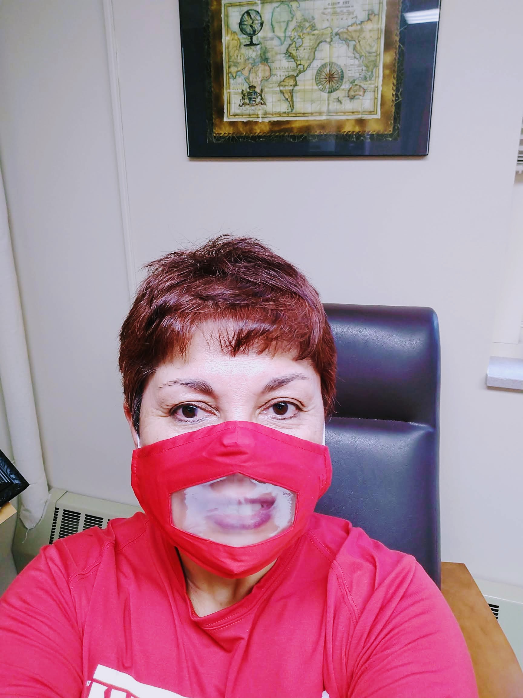 Jacqueline Rioja Velarde wears a mask with a see-through panel for the mouth