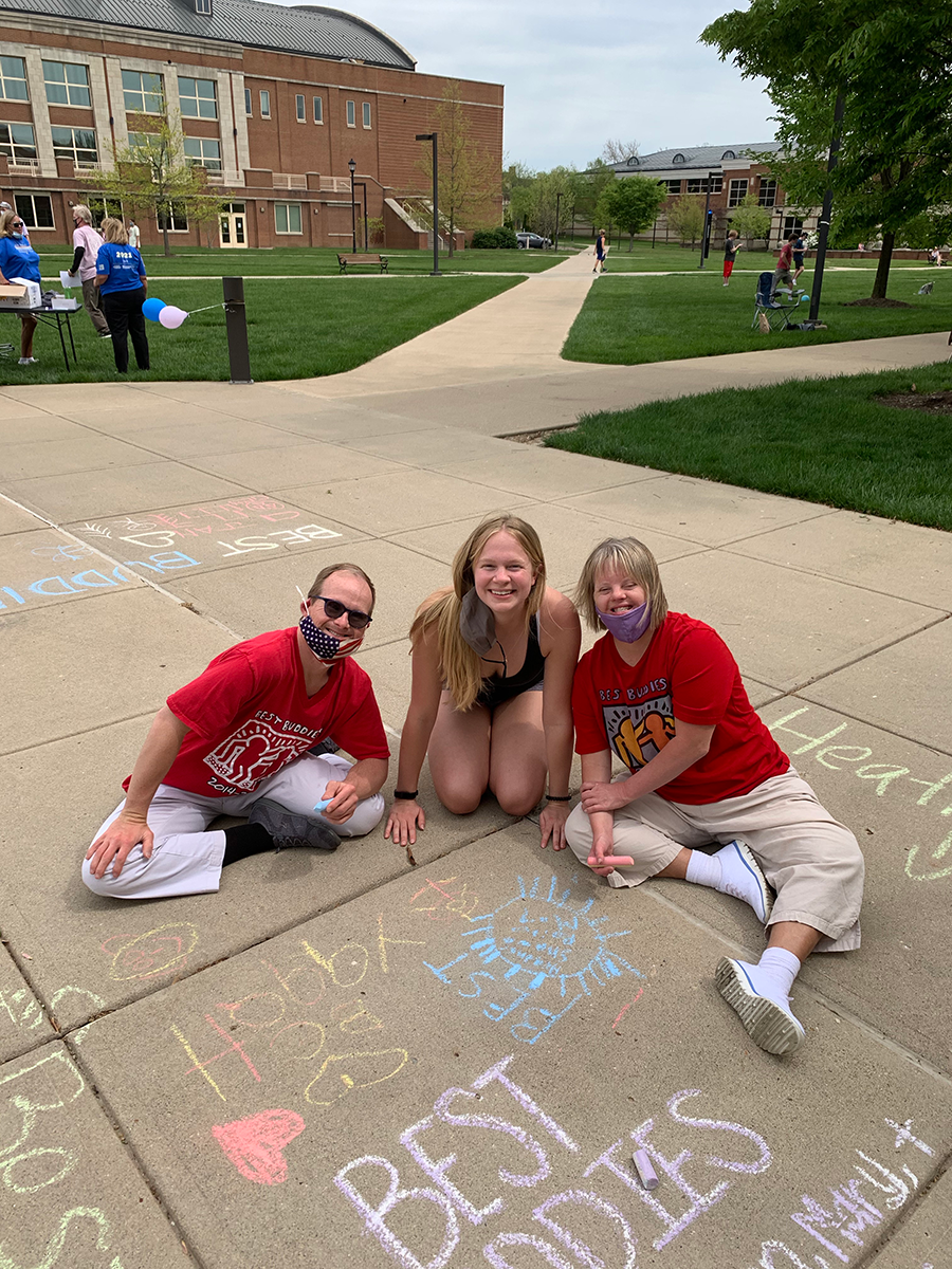 Mary poses with her Best Buddies friend and the friend's husband