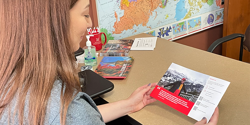 study abroad advisor looks at brochure