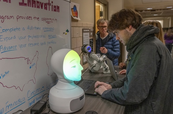 students huddled in discussion