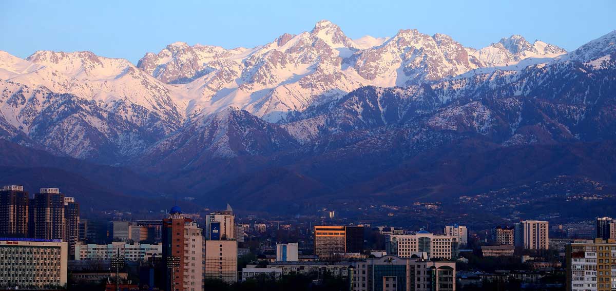 the city of Almaty, Kazakhstan skyline with a mountain range behind it