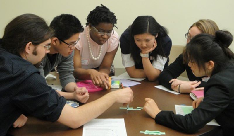 students huddled in discussion
