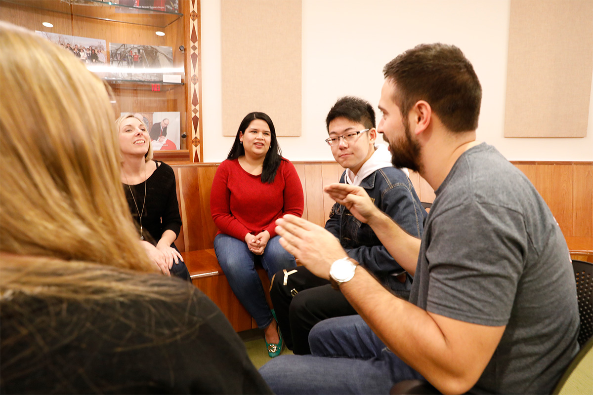 A group of students talking in the Center for American and World Cultures
