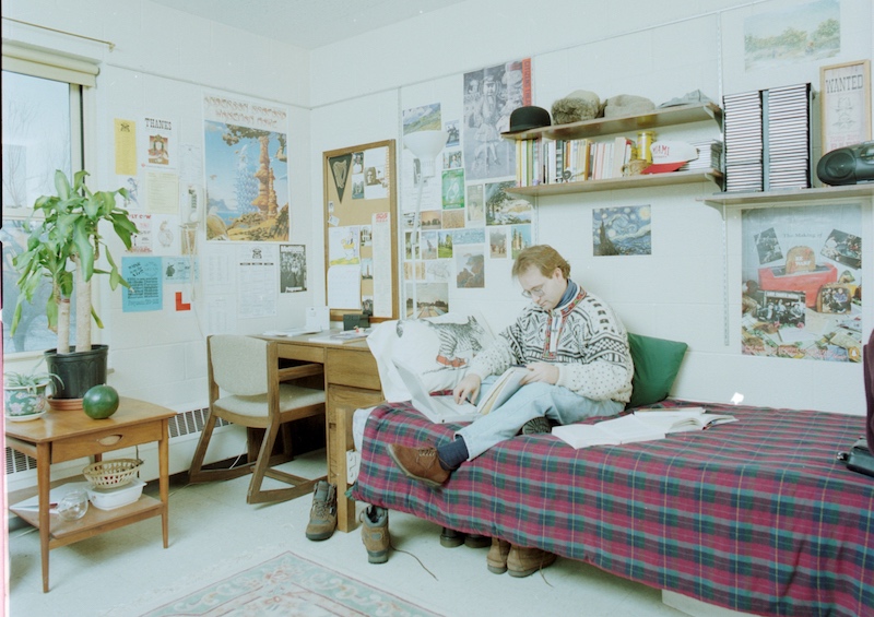 Miami student sitting in their dorm room in 1990s