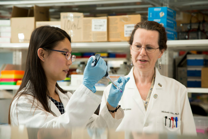 A student working with a professor in a science laboratory