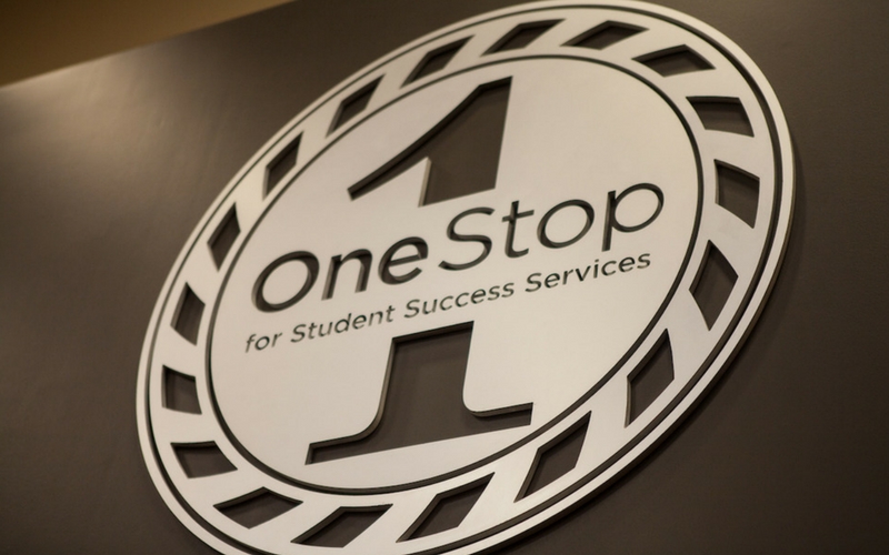 Wall sign of the One Stop logo found inside of the One Stop lobby