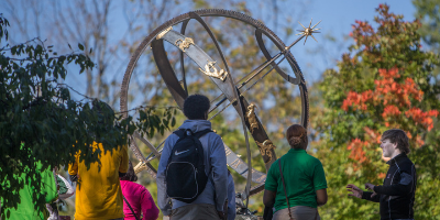 Students standing at the sundial on Oxford's campus