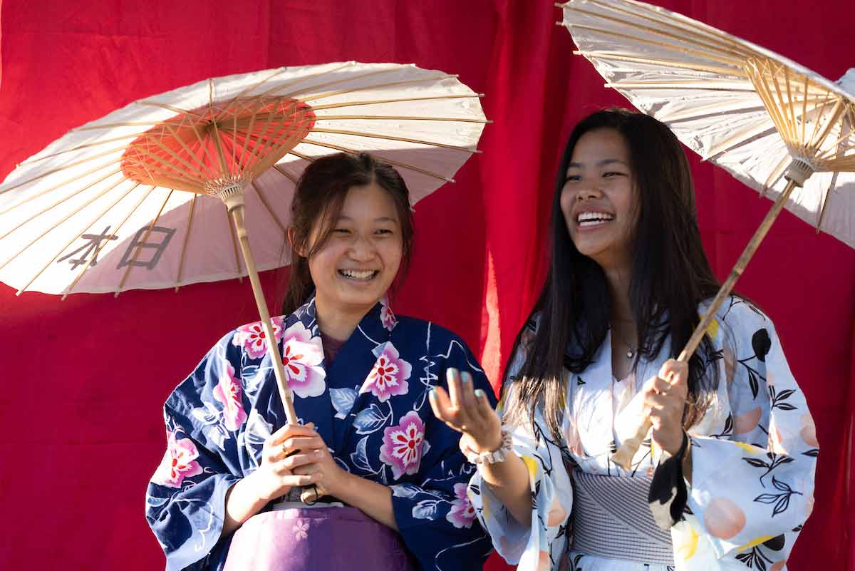 students in kimonos with umberellas